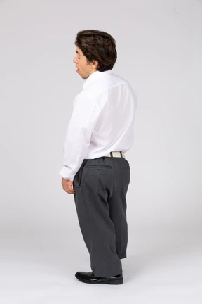 Back view of young man standing with his eyes closed