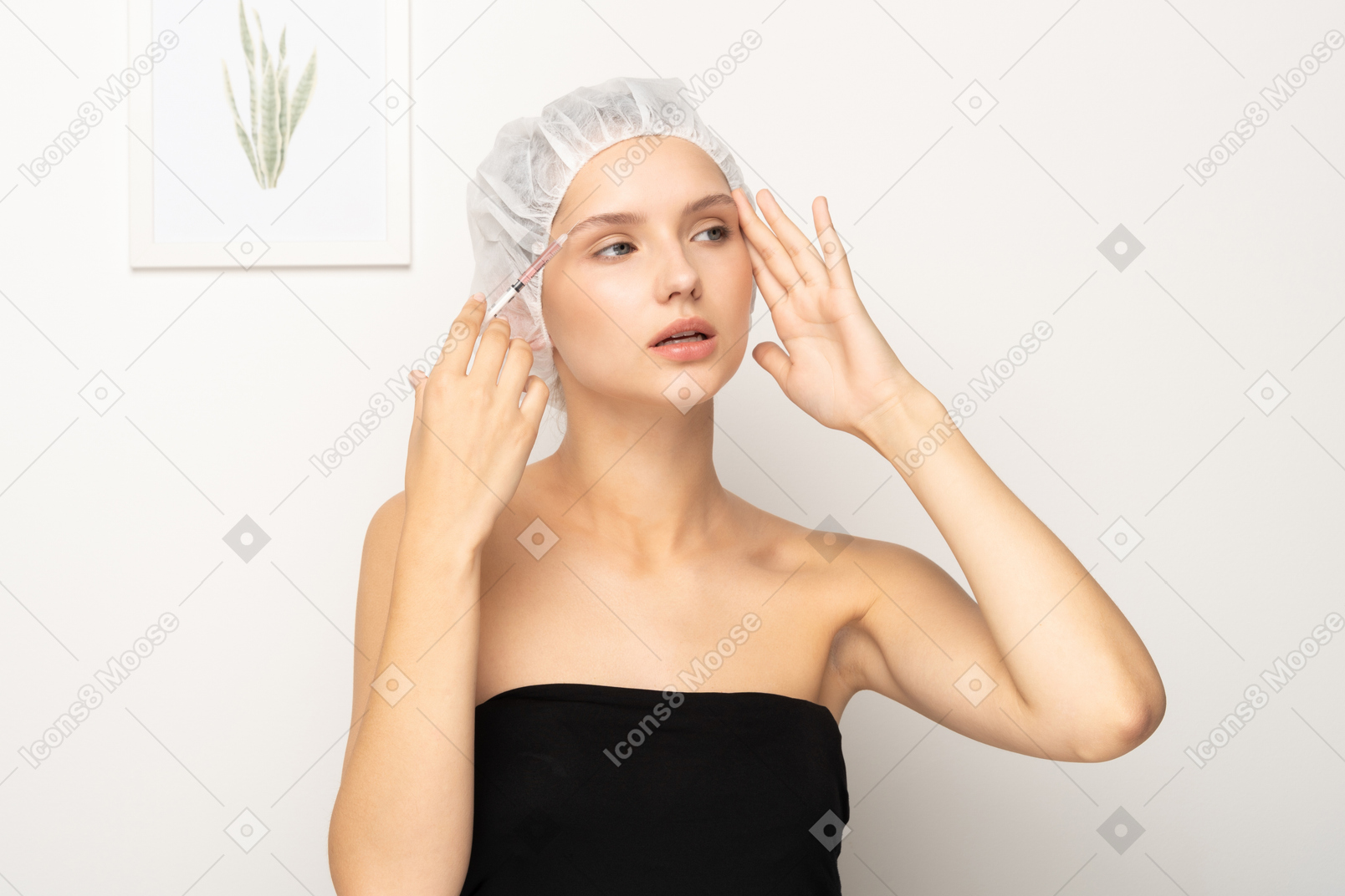 Woman making injection to her forehead