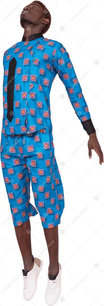 Black man in blue pajamas jumping