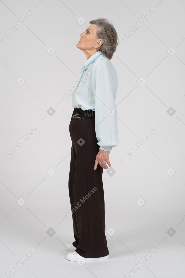 Side view of an old woman looking up with a disgusted expression