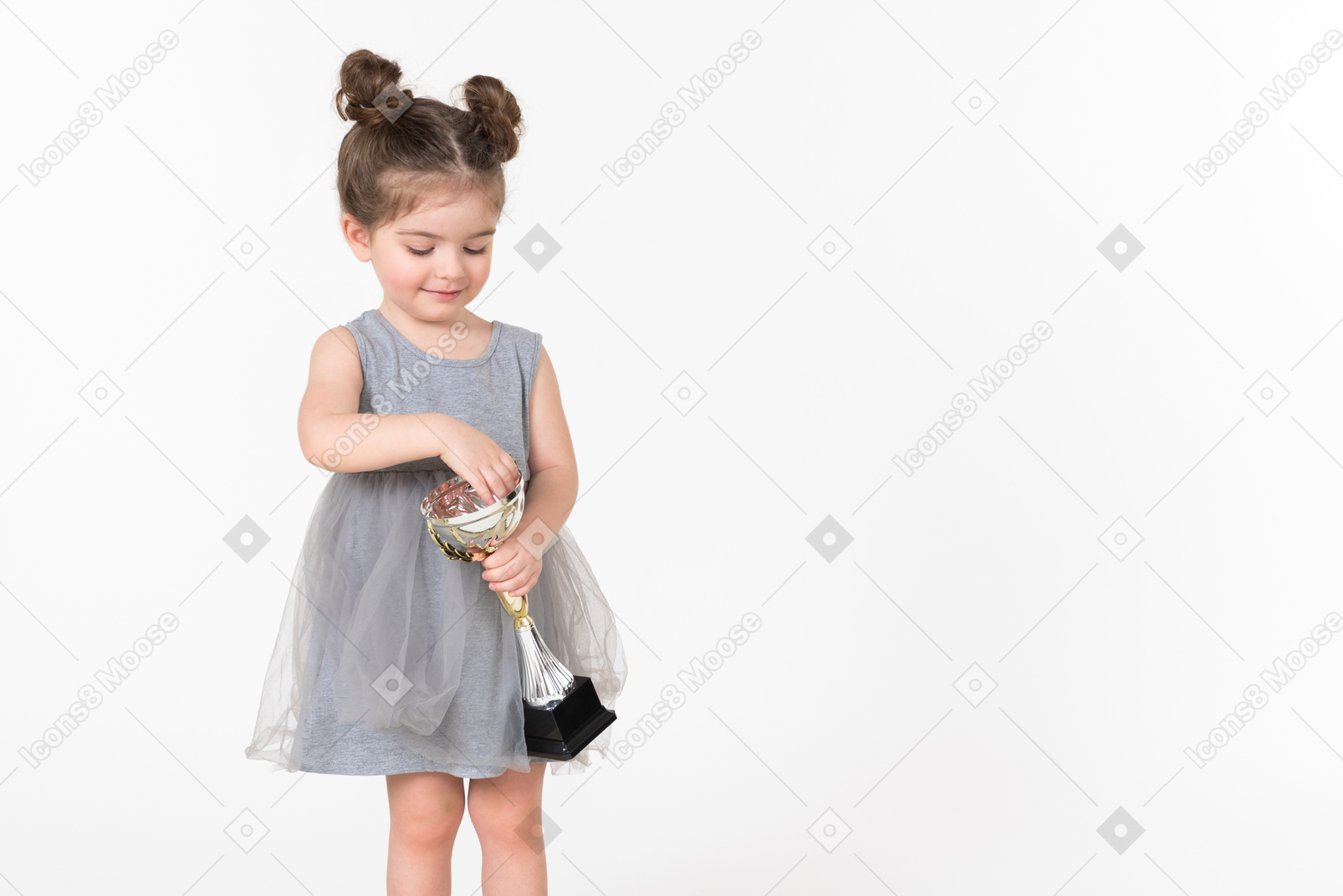 Little girl holding an award cup