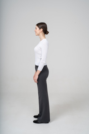 Side view of a woman in business casual clothes smiling