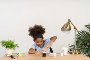 Good looking cute girl doing science at the table