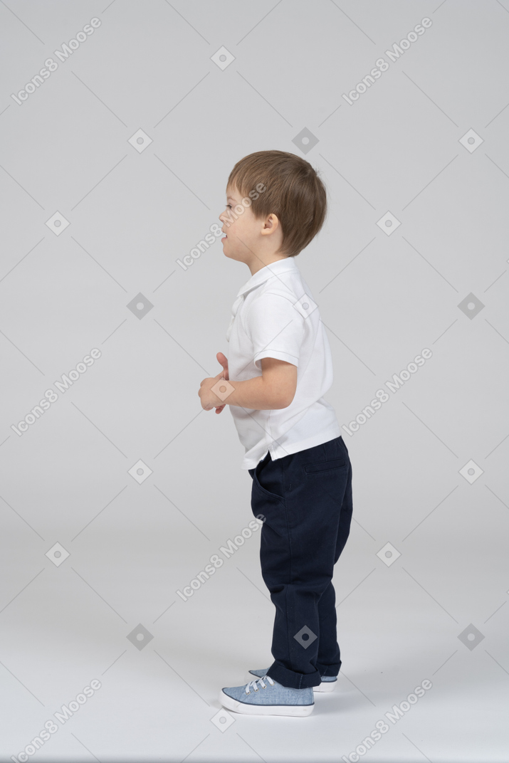 boy standing side view