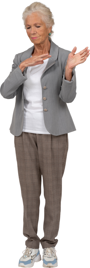 Front view of an old woman in suit gesturing