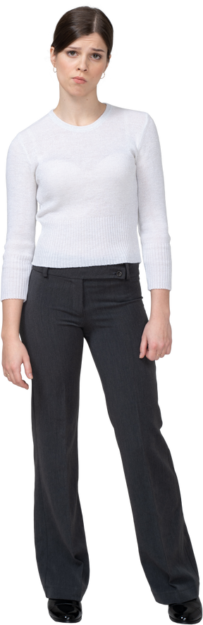 Front view of a displeased young woman in office clothing