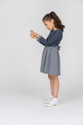 Side view of a girl examining the back of her palm