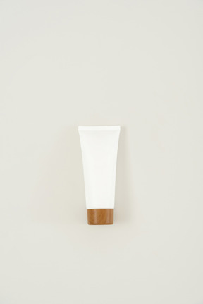 Cream tube with a brown cap