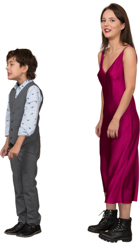 Woman in red dress looking at camera while boy standing near by