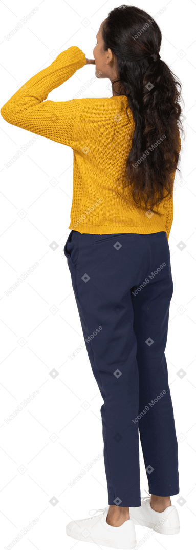 Rear view of a girl in casual clothes biting finger