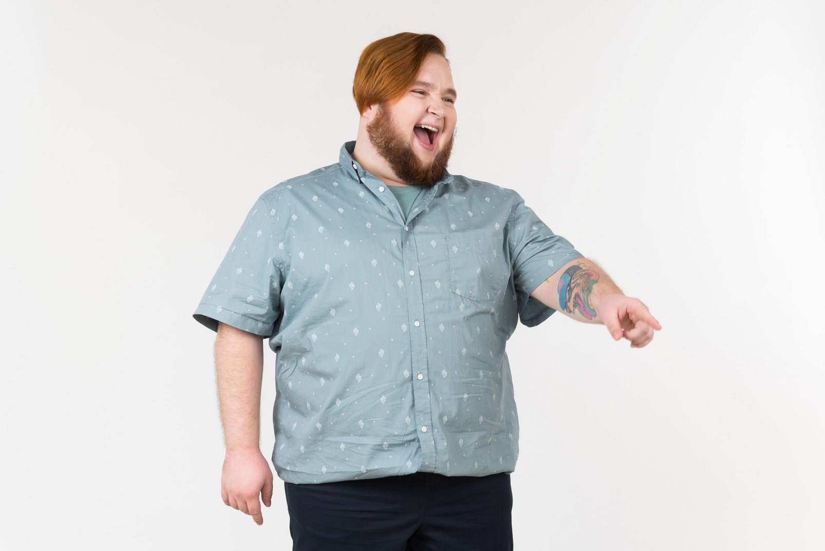 A fat man pointing his finger at something and laughing