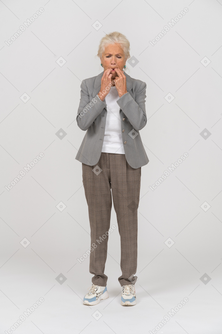Front view of an old lady in suit whistling