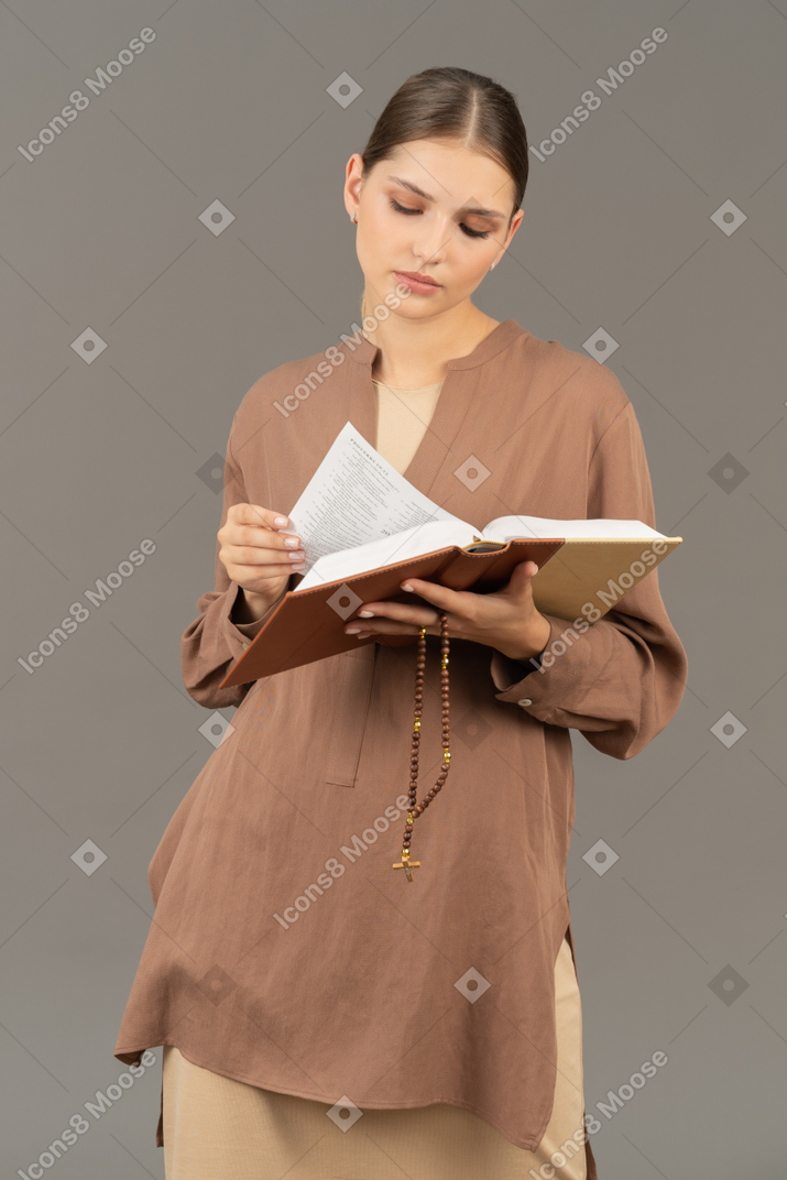 Young woman examining the book