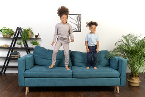 Good looking boy and girl play on the sofa