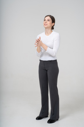 Front view of a woman in suit looking up and gesturing