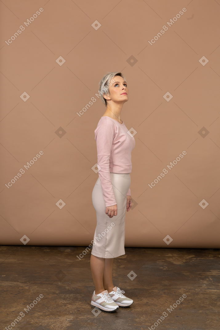 Side view of a woman in casual clothes looking up