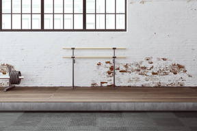 An old gym with shabby walls and simple sports equipment on the wooden floor