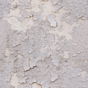 Old cracked paint layer on concrete wall