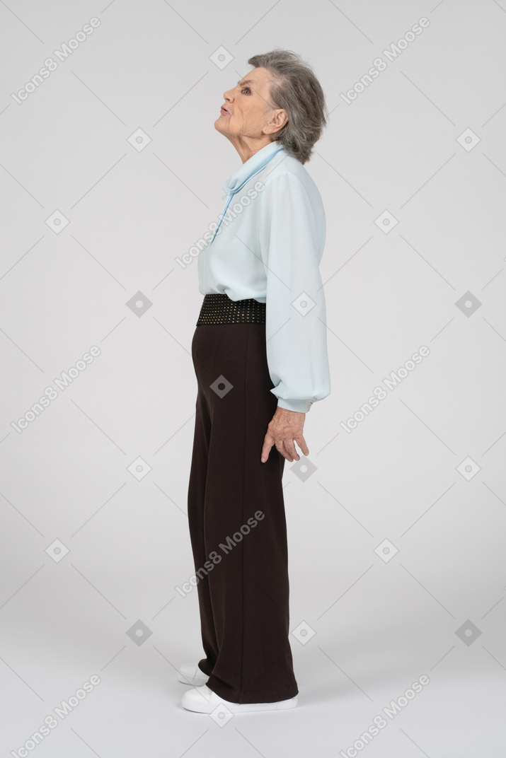 Side view of an old woman looking up with a disgusted expression