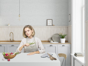 Linda jovem dona de casa na cozinha moderna