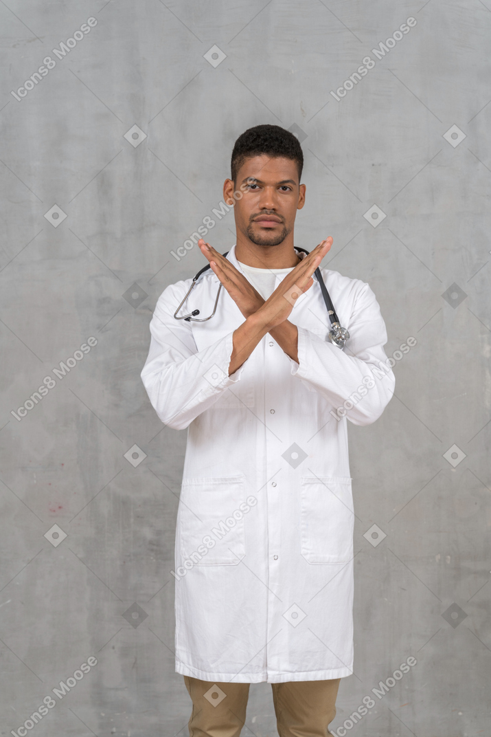 Male doctor making a stop gesture