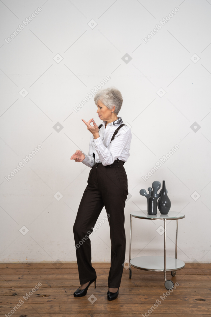 Three-quarter view of a thoughtful old lady in office clothing