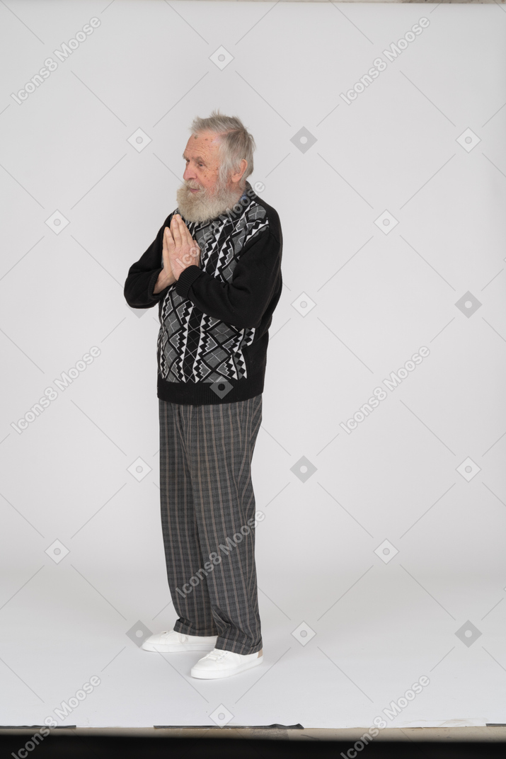 Senior man folding his hands in prayer
