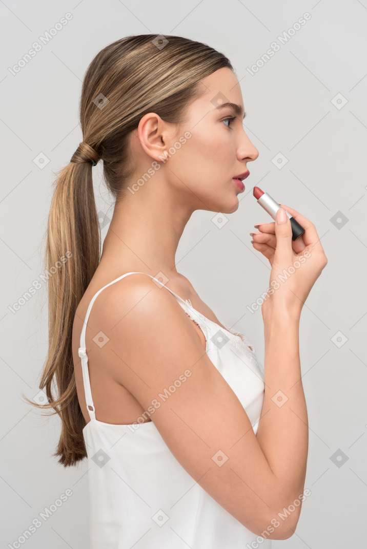 Applying makeup before heading out