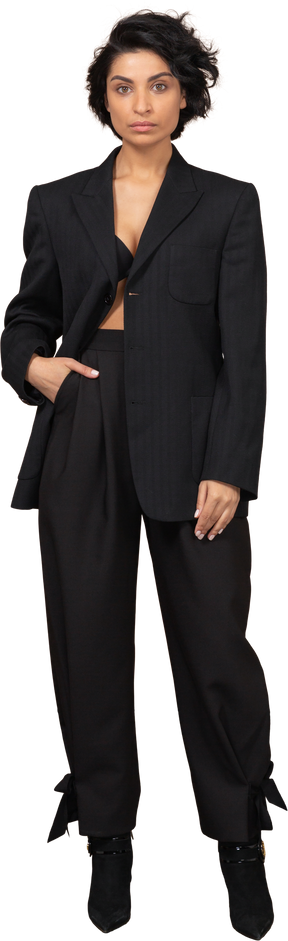 Front view of a businesswoman in a black suit looking seriously at camera