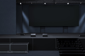 Dark stage with projection screen and spotlights