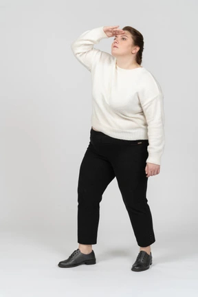 Side view of plus size woman in casual clothes looking for someone