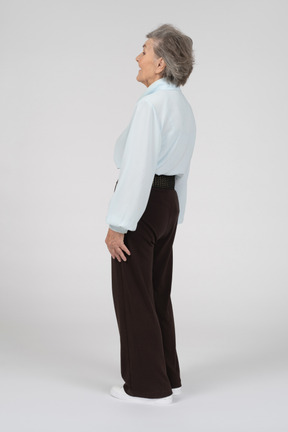 Vista posteriore di tre quarti di una donna anziana sorridente