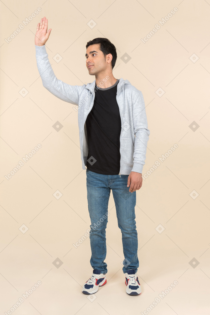 Young caucasian man waving