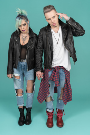 Two punks standing against camera and gesturing