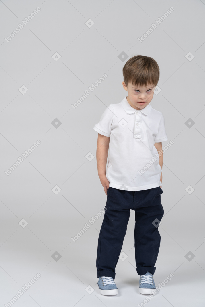 Front view of little boy looking irritated