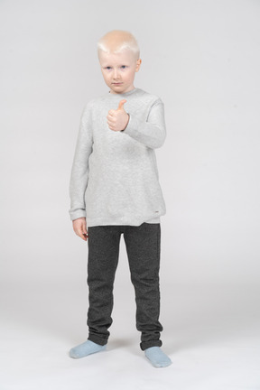 Little boy showing thumb up