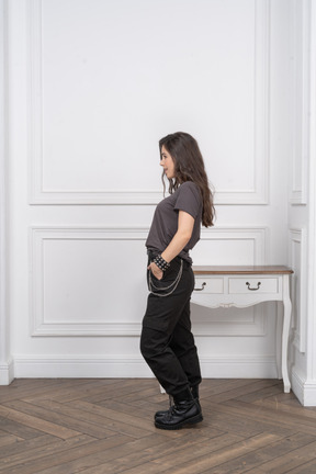 Side view of a contented female rocker putting hands in pockets