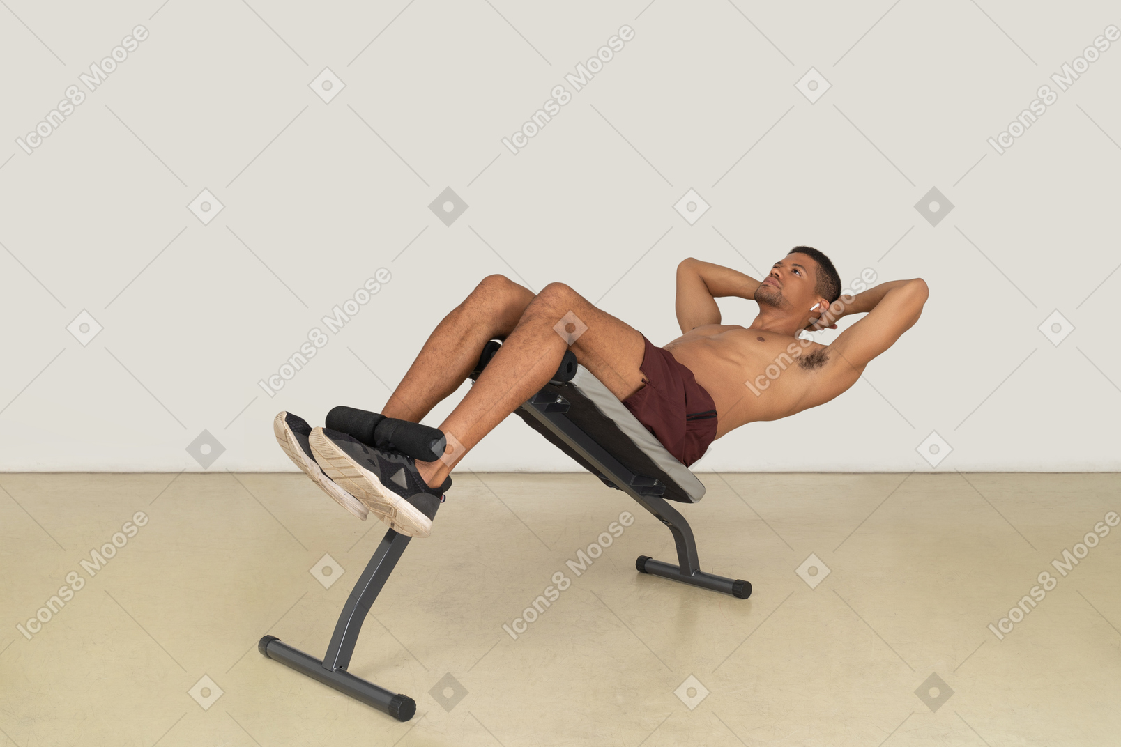 Young muscular man working out on weight bench
