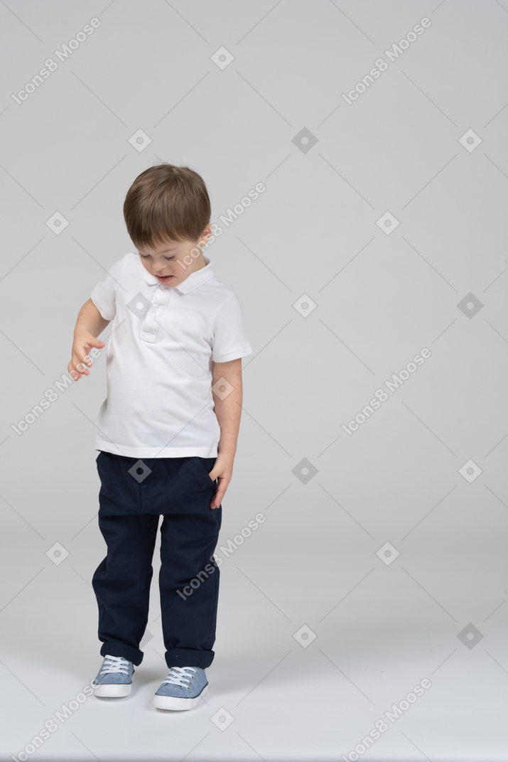 Front view of a little boy looking down