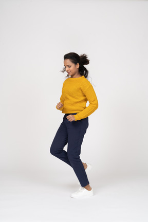 Side view of a girl in casual clothes running