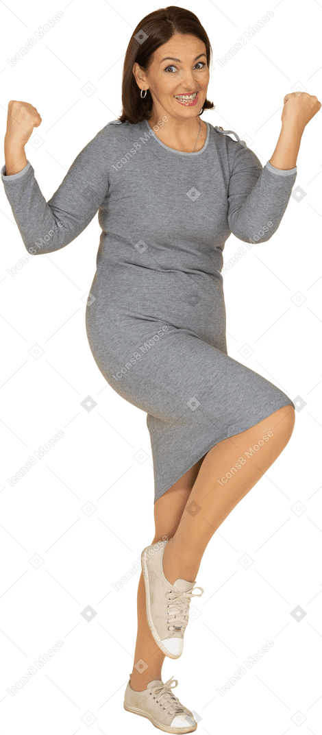 Front view of a happy woman in grey dress