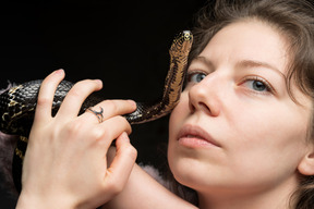 Striped black snake and a woman