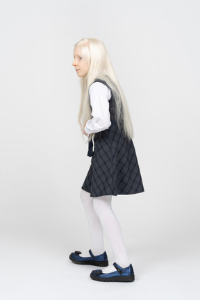 Side view of a schoolgirl anxiously looking around