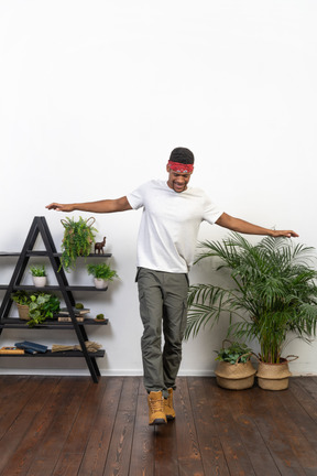 Good looking young man posing on the background of the apartment