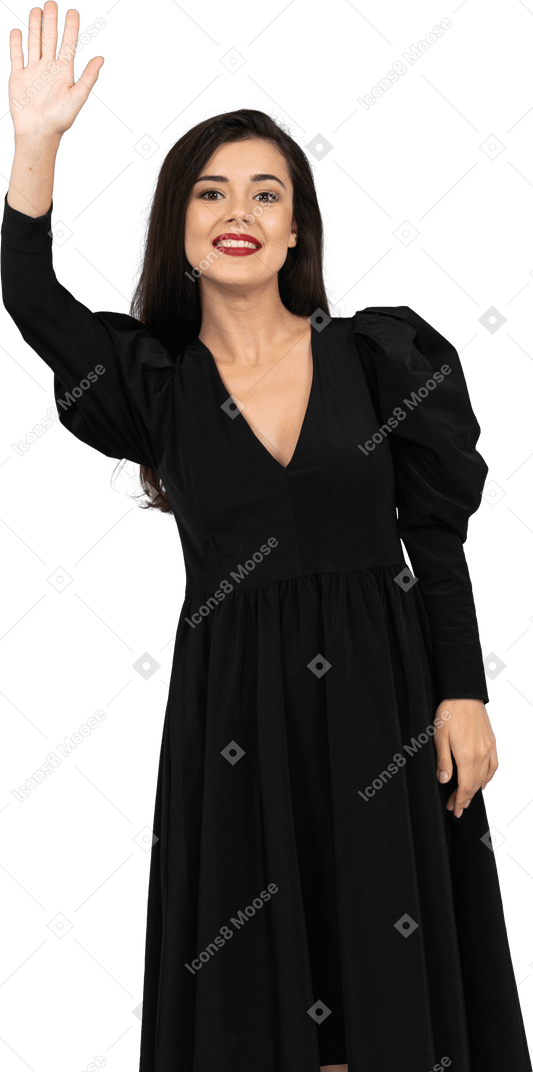 Front view of a smiling greeting young lady in a black dress
