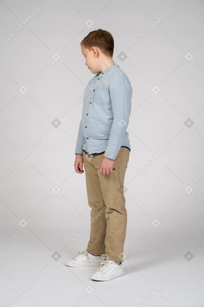 Three-quarter view of a boy looking down