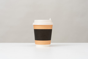 Plastic cup for hot drinks with a lid