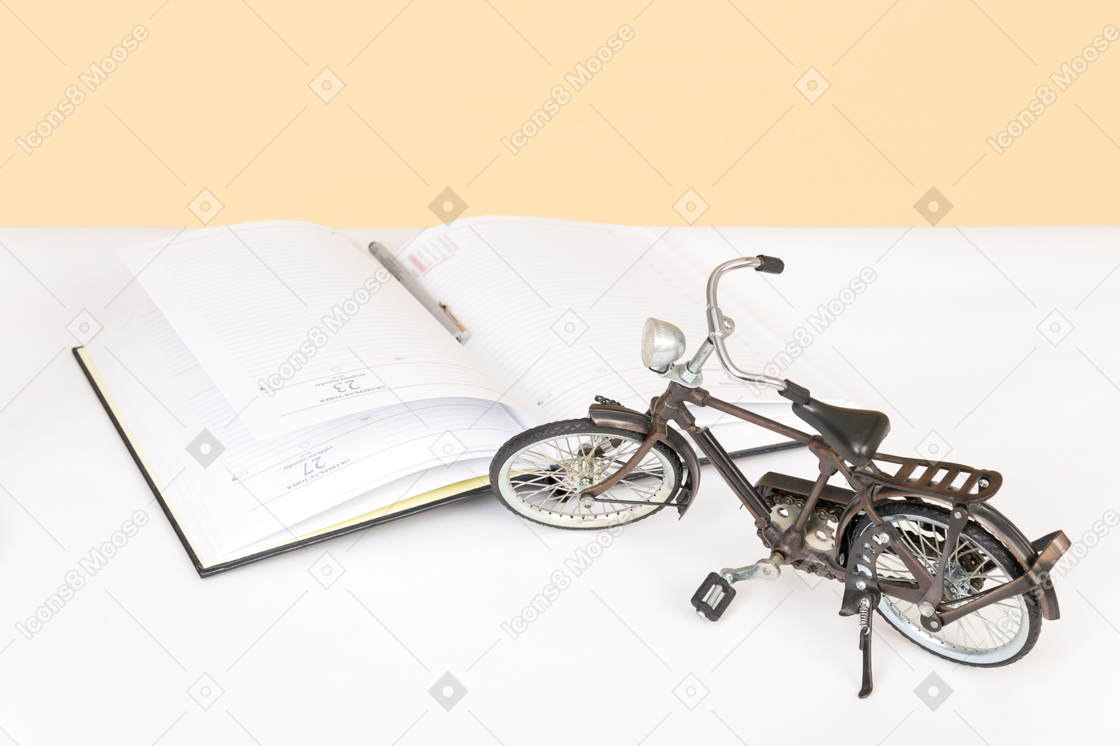 Black desk lamp, open book and toy bicycle