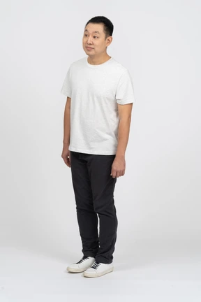Man in casual clothes looking at something with interest