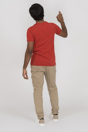 Back view of young man gesturing